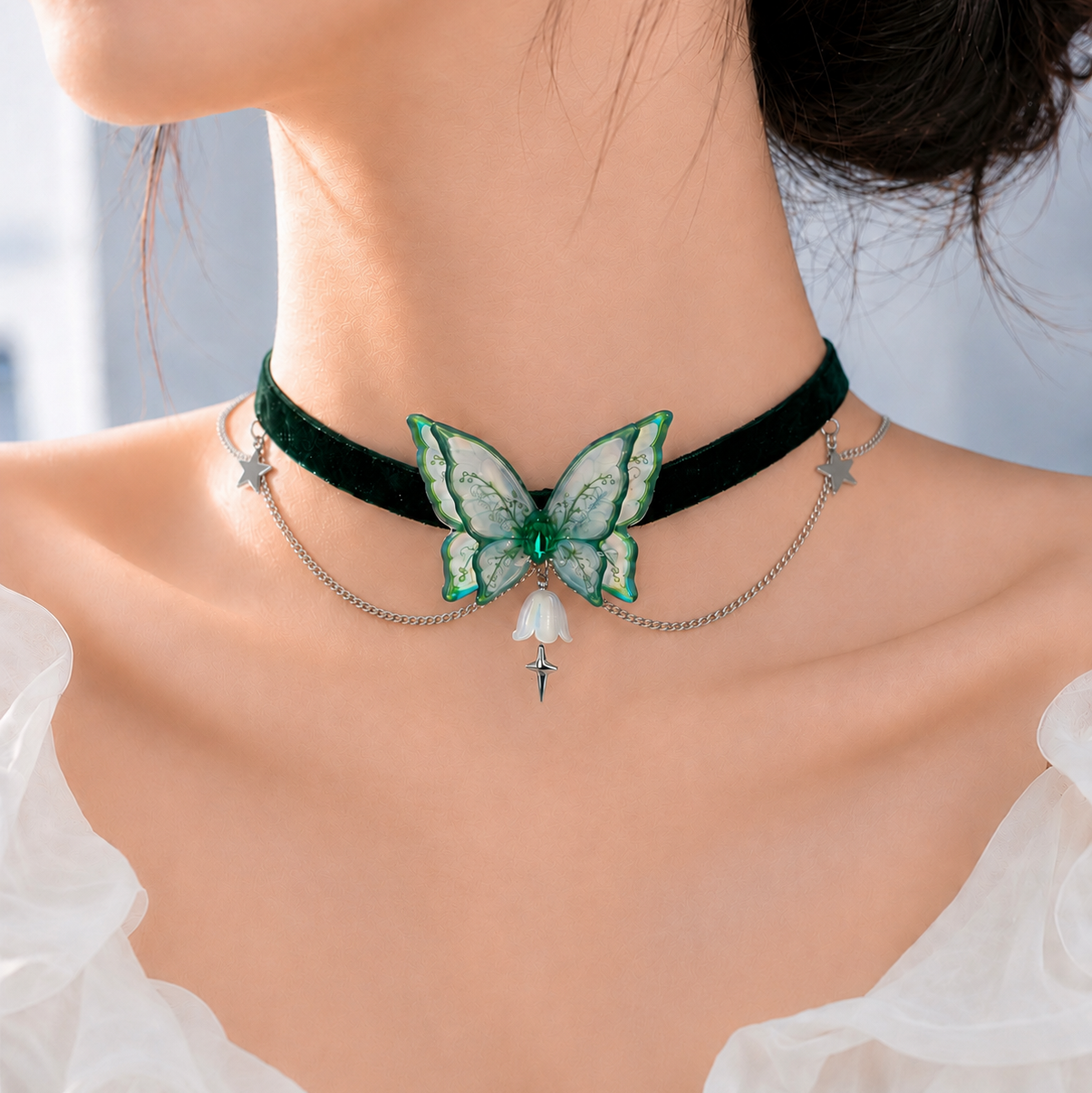 A close-up of a model's neck and upper chest wearing a black velvet choker necklace with a green butterfly centerpiece, silver chain drapes, and small dangling charms.